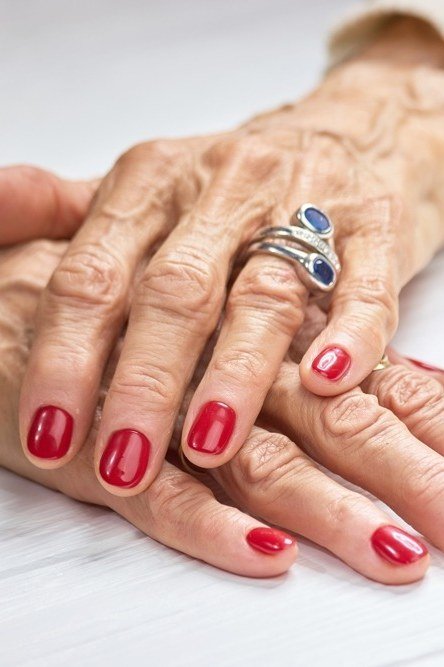 Classic red nails on very old hands, best manicure idea for women over 60