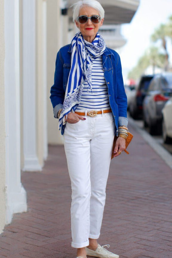 Easy casual outfit idea for women over 50: denim jacket, striped tee, white pants, older woman everyday style