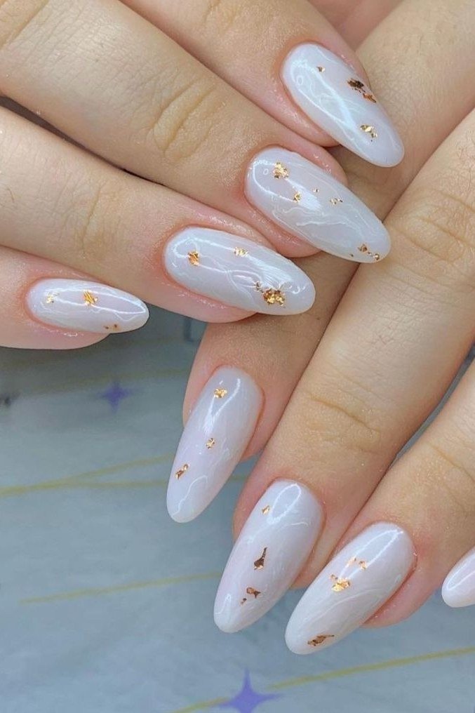 Milky white nails with gold flake confetti