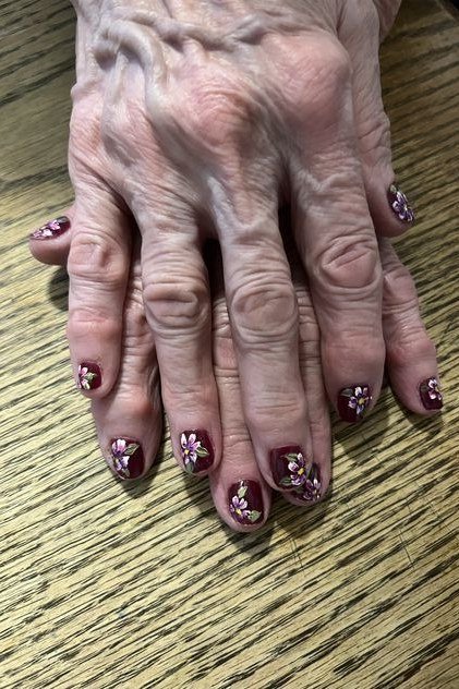 Nail art design for women over 60: navy blue nails with white polka dots