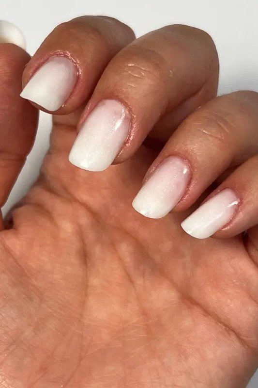 white pink baby boomer fade on short square nails mature hands