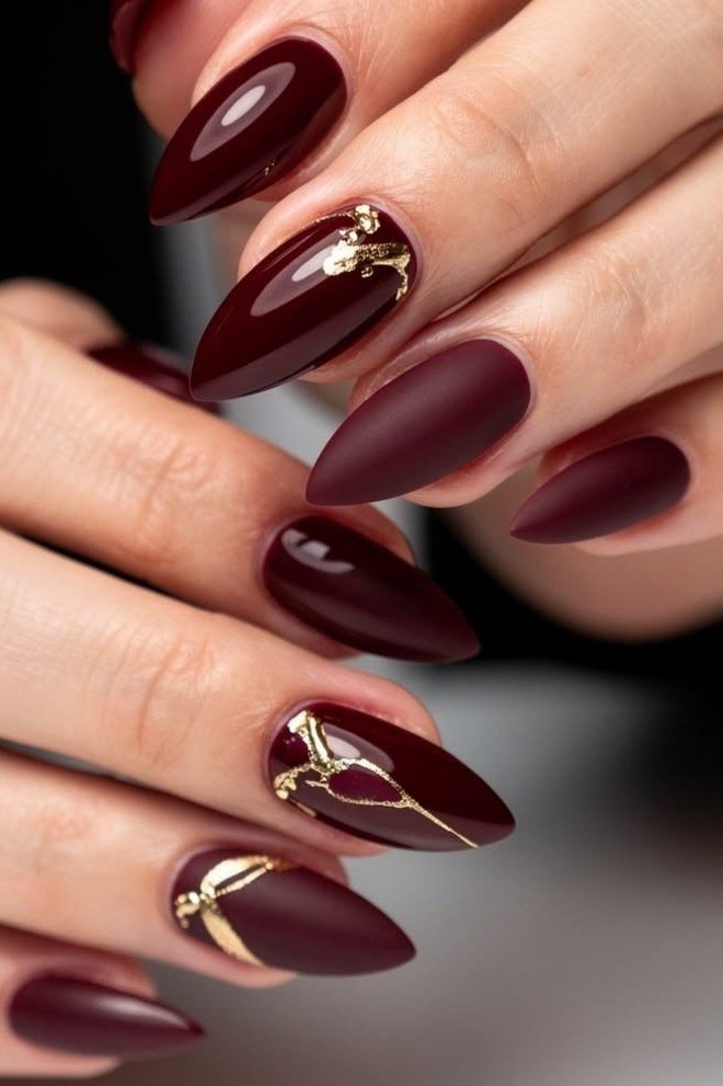 Matte burgundy with gold line art, burgundy fall nail idea for women over 60