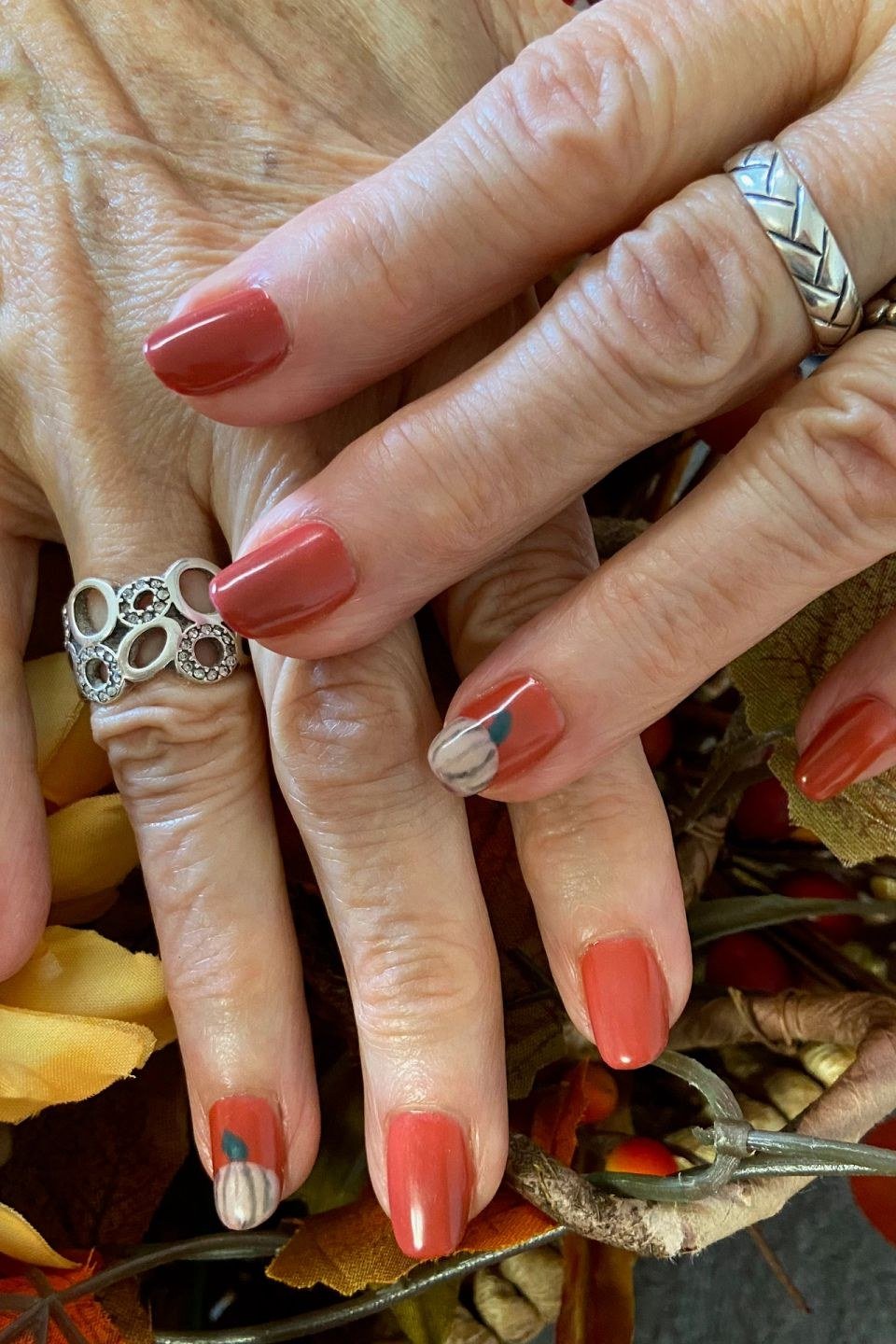 coral red nails with autumn floral art