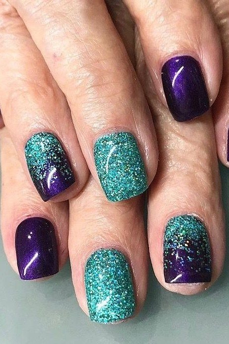 deep purple with teal glitter accent nails - winter nail trend for older women