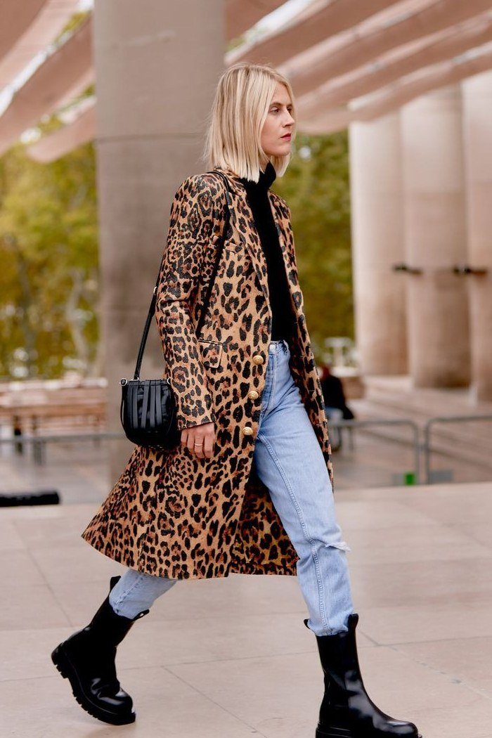 Casual fall outfit for women over 60: olive field jacket, cream sweater, dark jeans