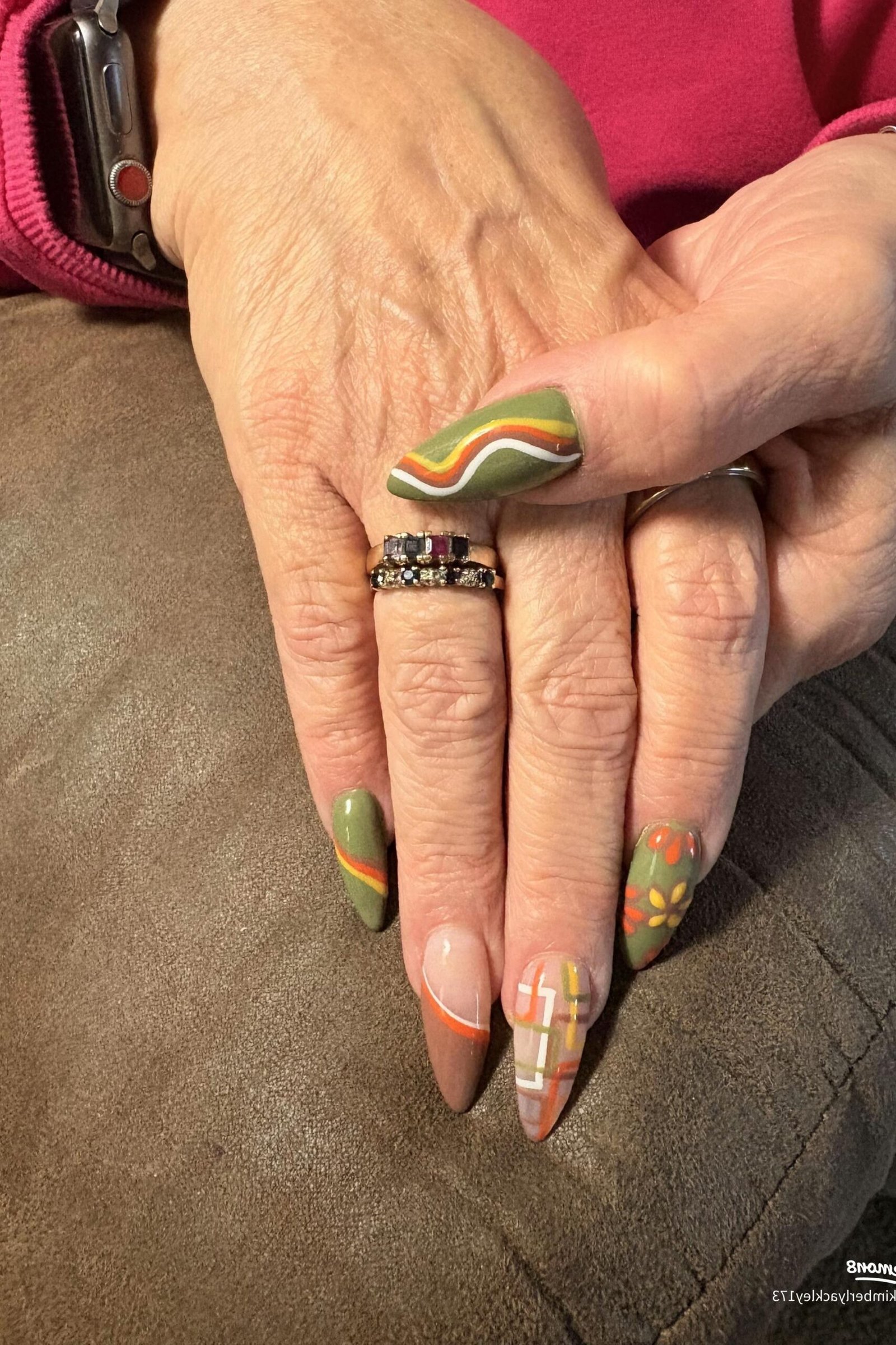 Sage green and gold marble nails on mature hands, fall nail design for older women