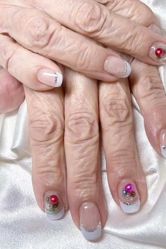 White gel nails with tiny floral art for mature hands