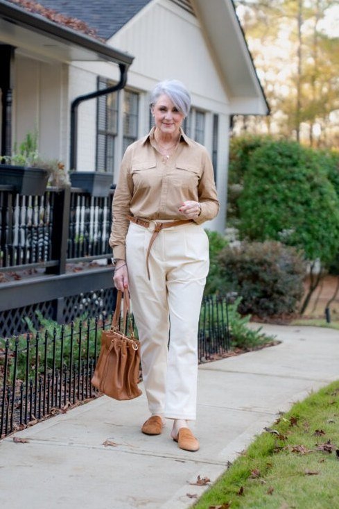 Tan button-down shirt with white wide-leg trousers and tan tote