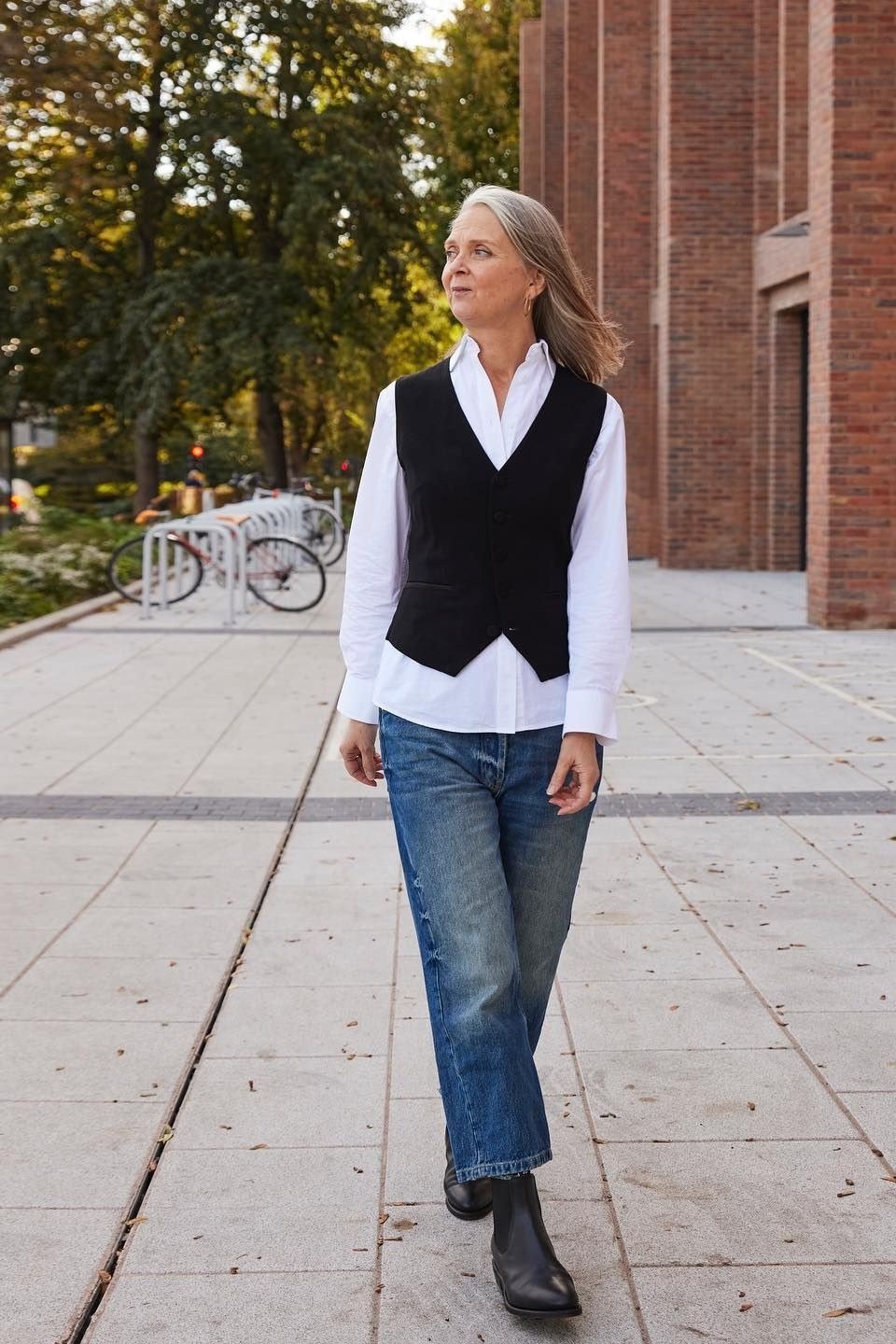 black knit sweater vest white shirt blue jeans ankle boots women over 50
