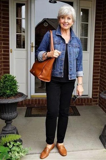 Woman over 50 wearing denim jacket with black pants and tan loafers, everyday casual outfit idea