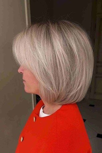 pastel grey-pink bob, side view — chin-length layered bob hairstyle for women over 50
