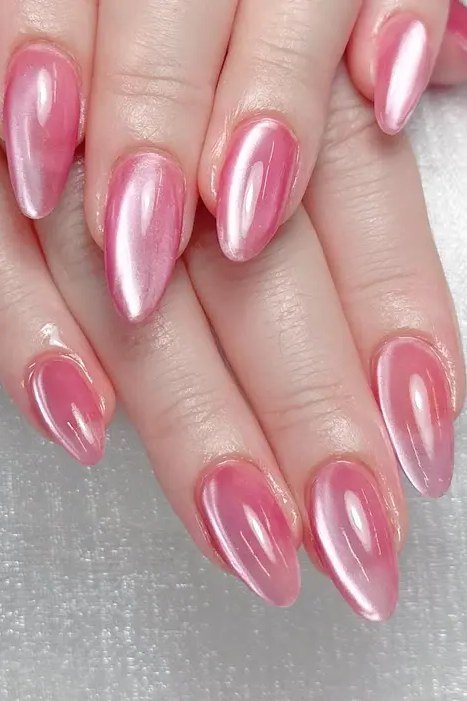 Pink Glass Cat Eye Nails - Sheer pink with a glowing magnetic light streak covers these medium length almond nails.