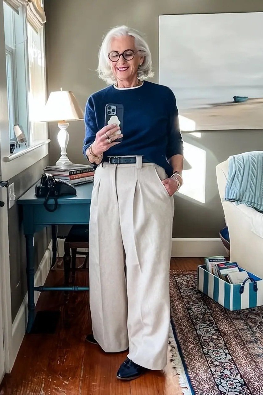 navy sweater with ivory wide trousers and navy flats for women over 50