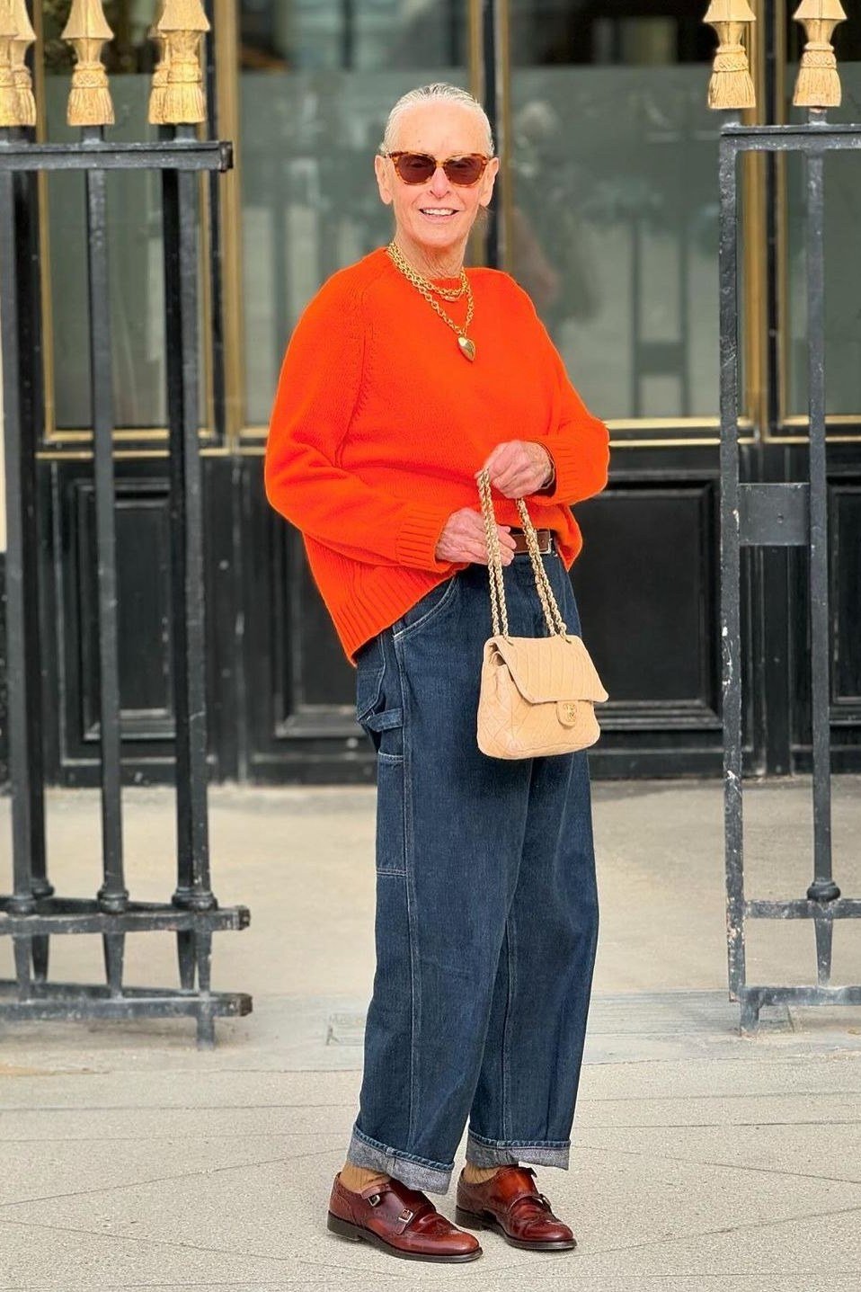 Casual fall outfit for women over 60: black leather jacket, grey turtleneck, black jeans