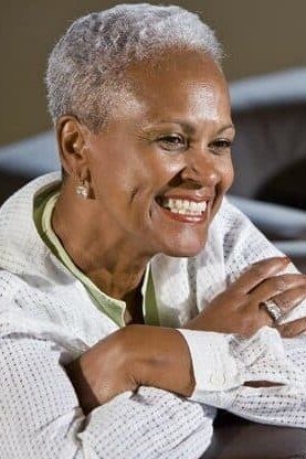 Sleek grey bob haircut for women over 70 with glasses, side view