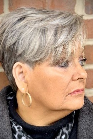 Silver wispy pixie with textured top against brick wall