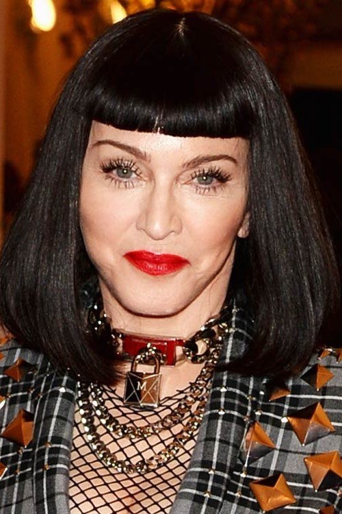 black layered bob with bangs, front view — chin-length layered bob hairstyle for women over 50