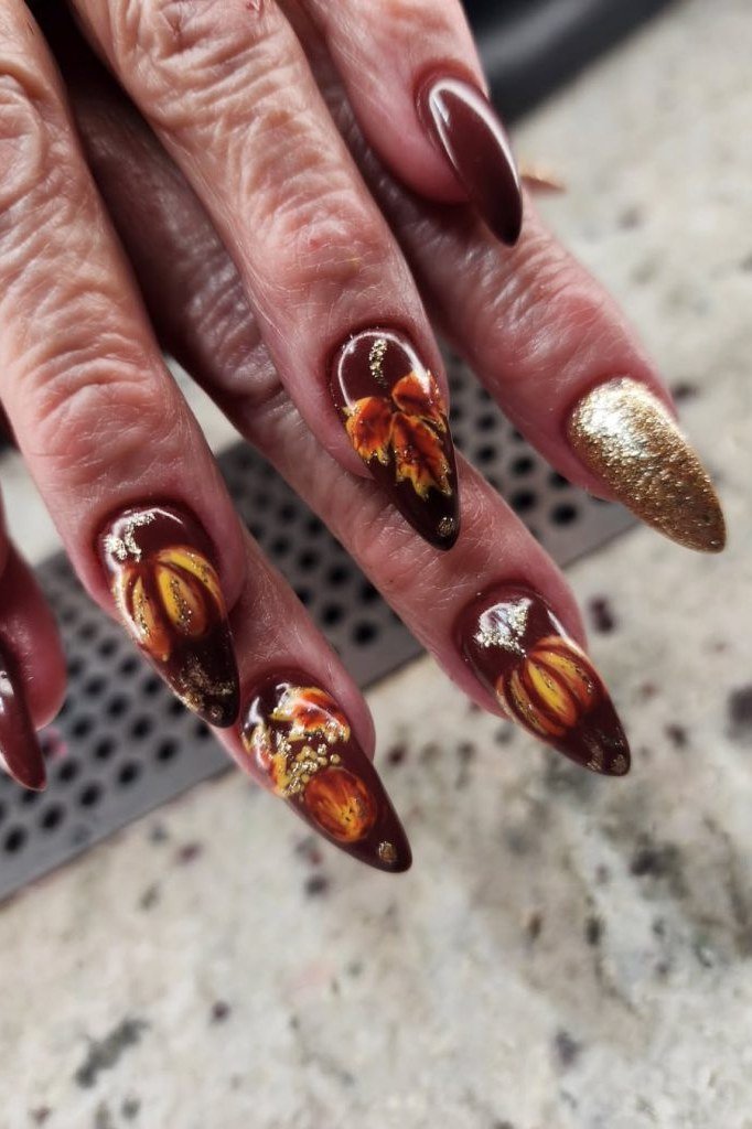 Fall leaf nail art on stiletto nails over mature hands