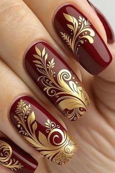 Gold leaf on burgundy almond, burgundy fall nail idea for women over 60