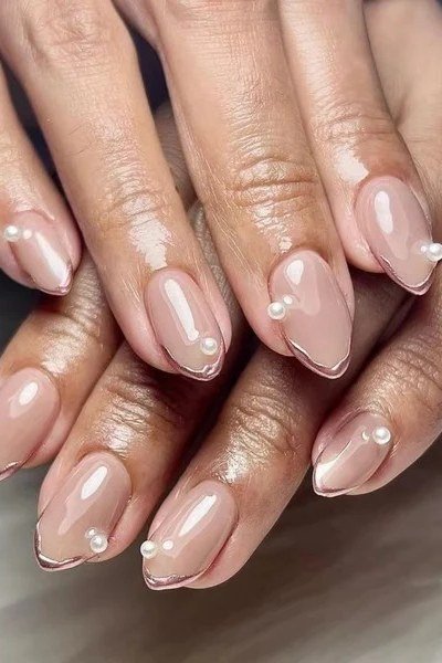 nude almond nails with pearl accents
