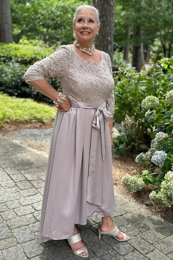 Black evening gown with sheer neckline in restaurant for women over 50, fall date night outfit