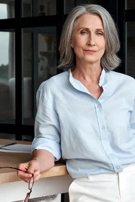 Light blue shirt with white trousers for women over 70