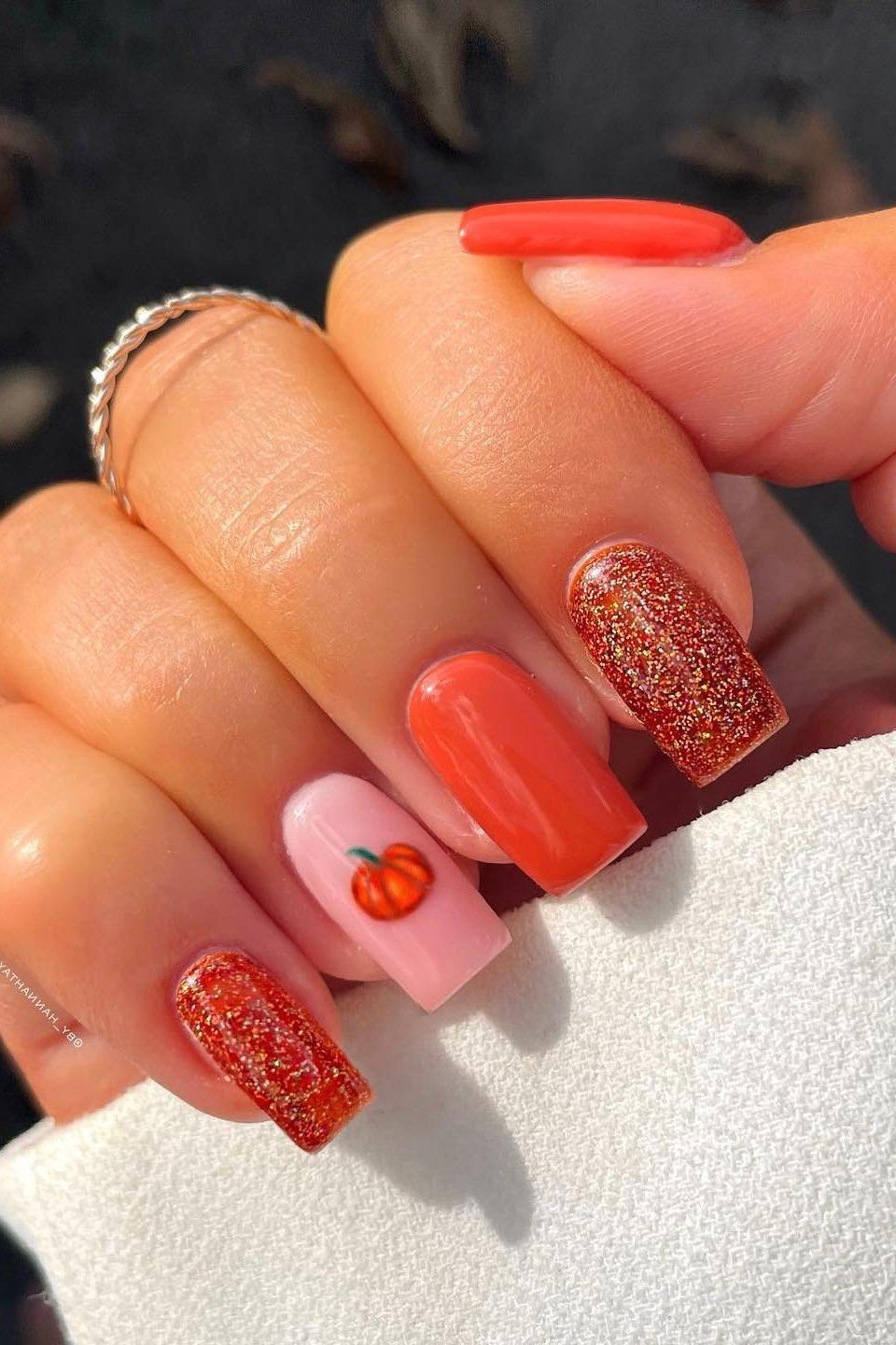 Coral glitter pumpkin nails, fall nail design for women over 60
