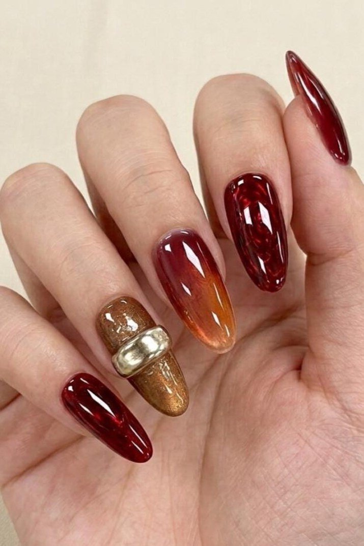 Burgundy ombre gel nails with gold glitter accent, fall gradient manicure