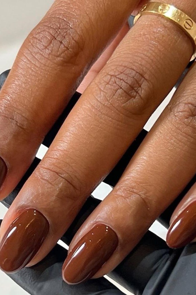 Cognac Brown Oval Nails on Mature Hands - old money fall nail color for women over 40