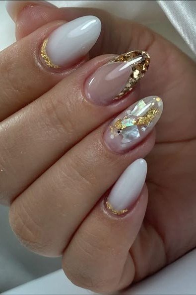 Milky white nails with a gold chrome accent nail