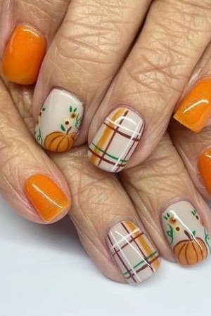 Bright orange nails with pumpkin plaid fall art on older hands