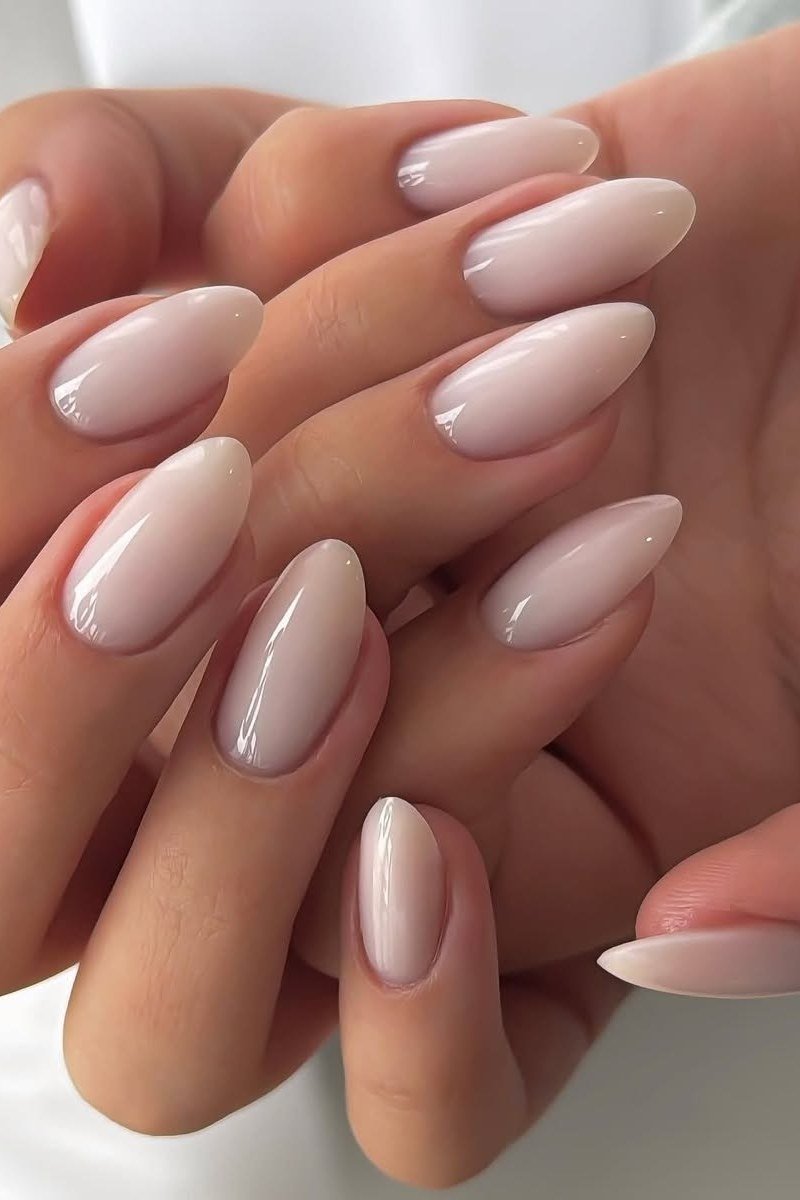 Glossy nude almond gel nails for mature hands