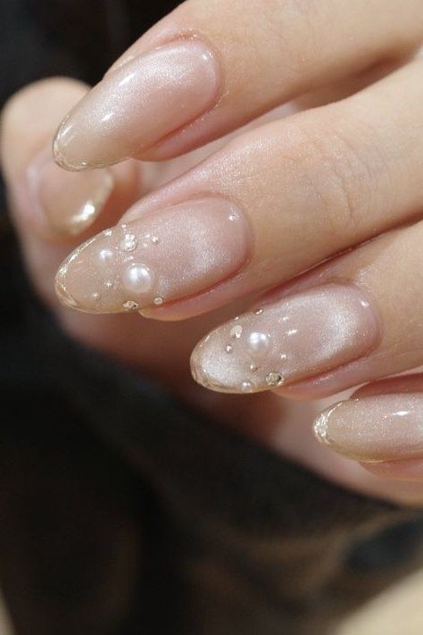 pearl shimmer almond nails with pearl accents