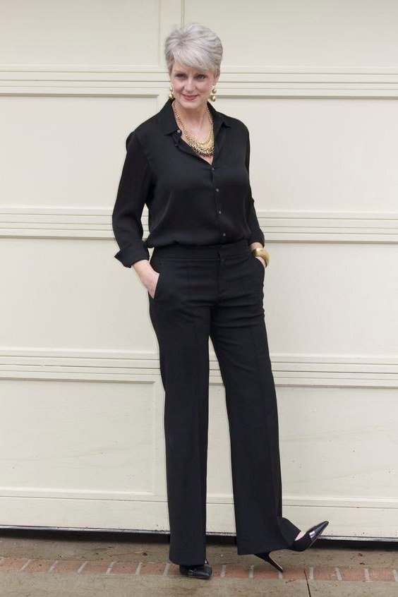 black shirt with black wide trousers and heels for women over 50