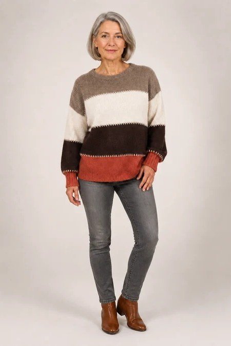 Color-block sweater in cream brown and rust with gray jeans and tan booties