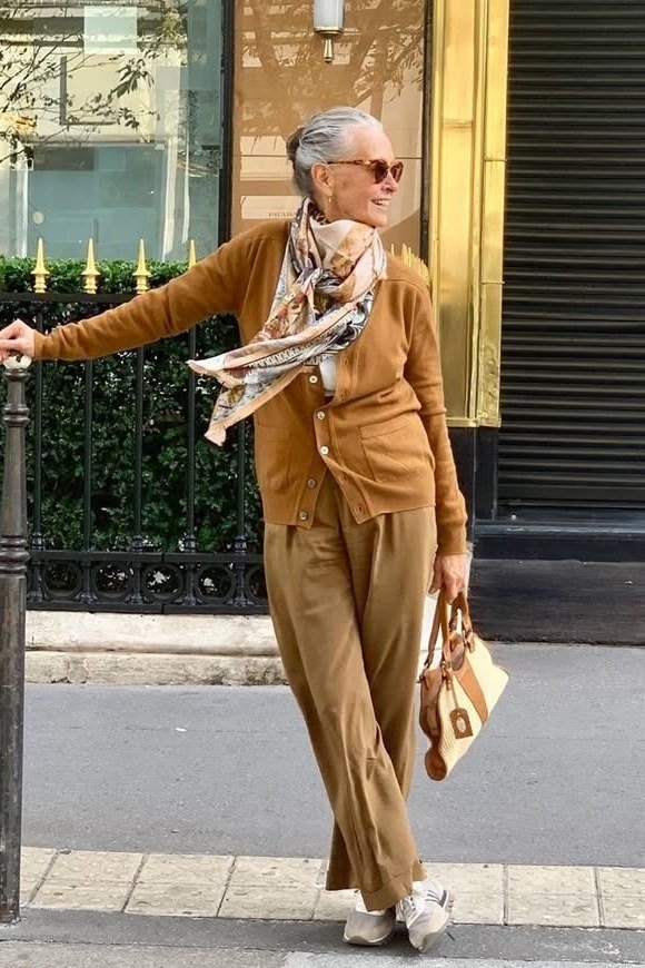 Casual fall outfit for women over 60: grey blazer, white tee, dark jeans, white sneakers