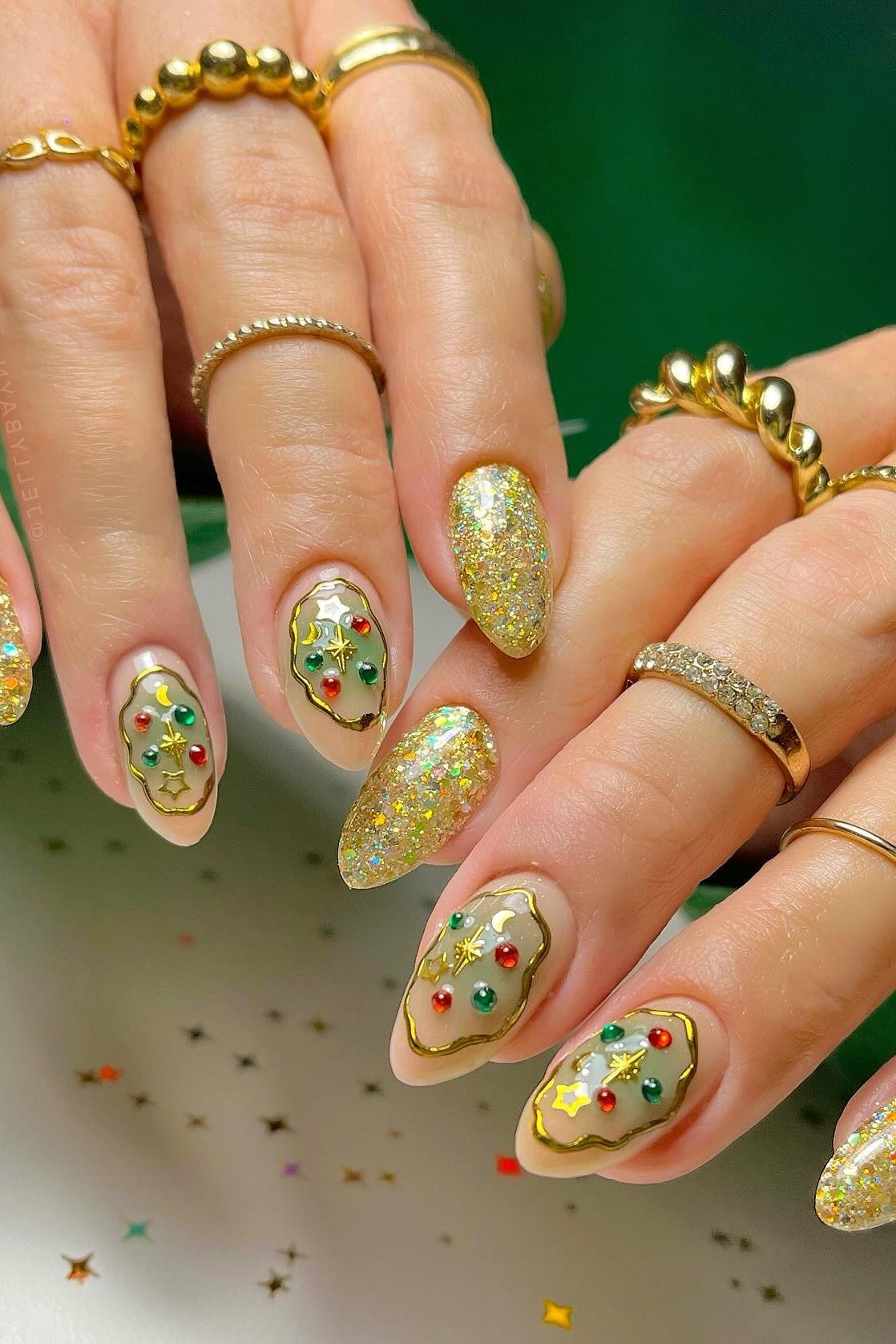 gold glitter nails with tiny christmas nail art