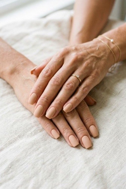 Pale Nude on Aged Hands, White Sheet - short nude nail idea for women over 50