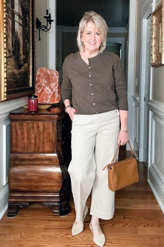 Woman over 50 wearing brown henley with cream wide-leg pants, everyday casual outfit idea