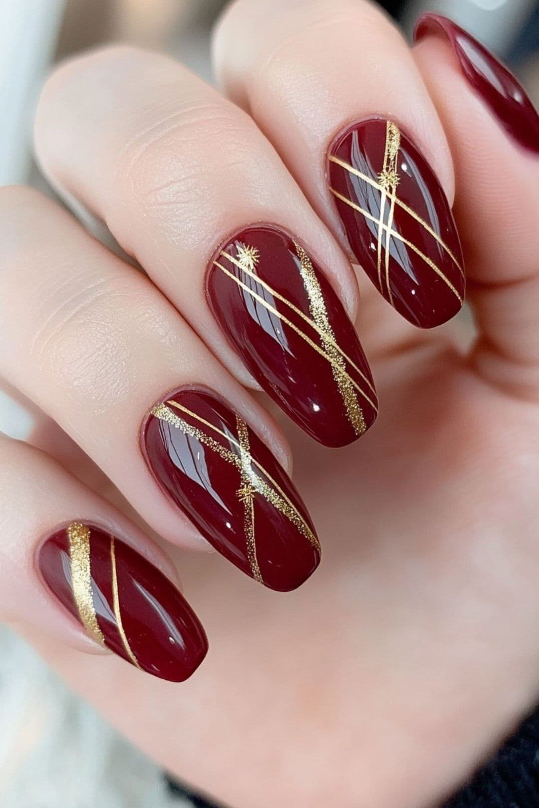 Burgundy with gold line art, burgundy fall nail idea for women over 60