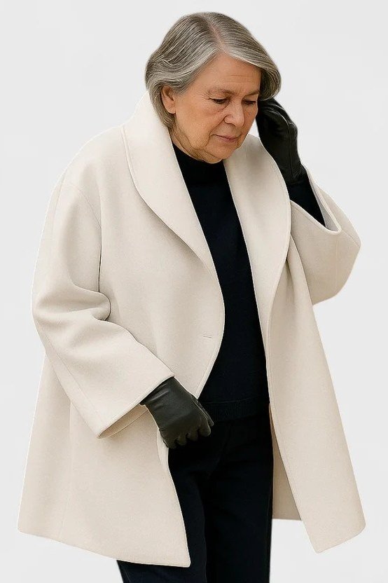 Cream coat over a black top for women over 50 at work