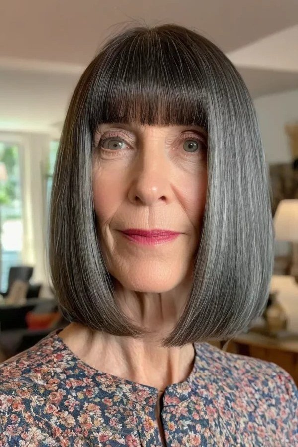 grey straight lob with blunt bangs, front view for women over 50