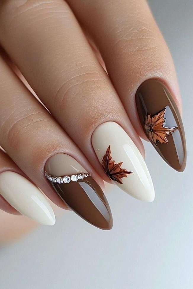 White and milk-chocolate brown with copper maple leaf art, long almond, glossy, rhinestone accent line, fall nail color for women over 40