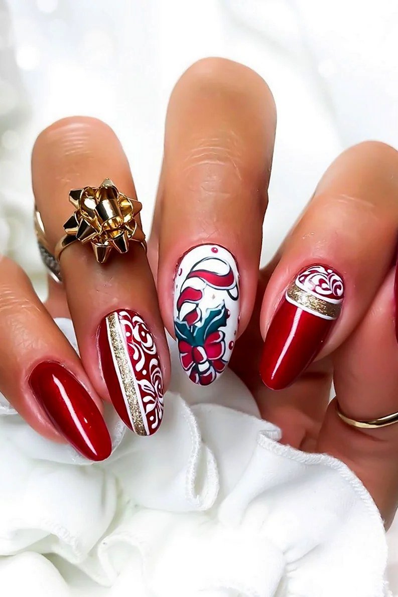 Red with white sweater-knit accent nails and gold bow ring - Christmas nail design for older women