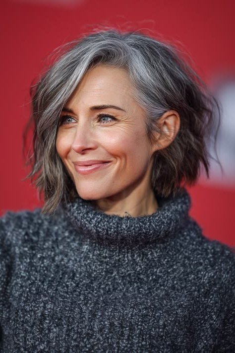 Tousled gray shaggy bob hairstyle for women over 60, front view