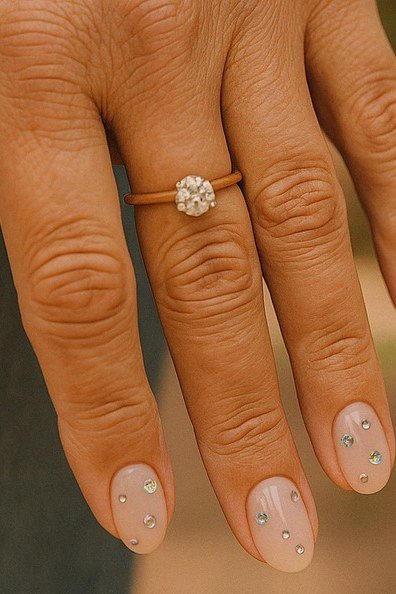 sheer nude oval gel nails with tiny crystal dot art, delicate nail art for mature hands