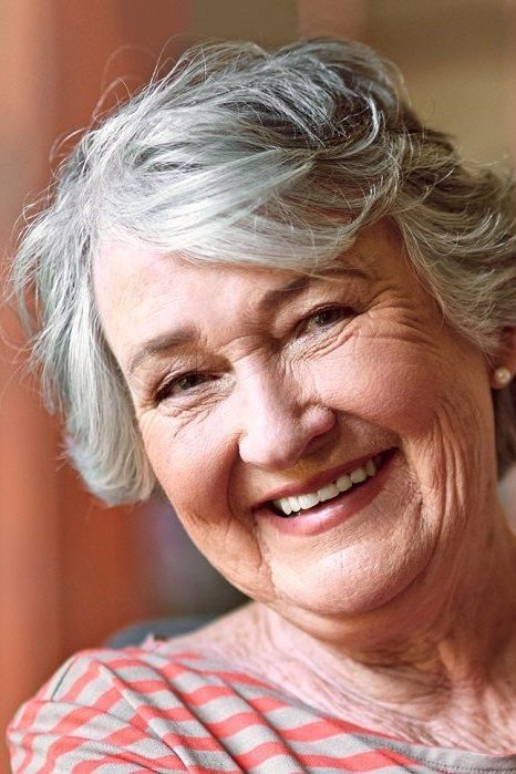 Gray curly bob, big smile, timeless hairstyle for women over 70