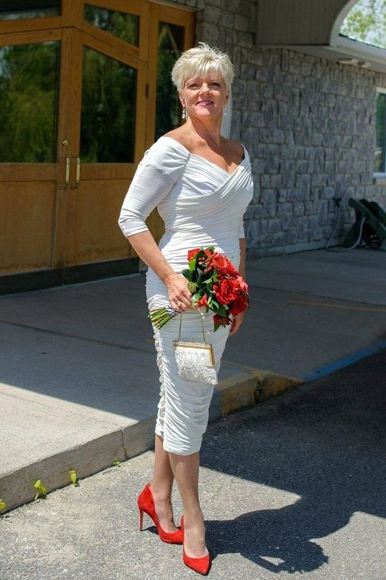 White sheath dress with 3/4 sleeves and red heels - wedding guest outfit for women over 50