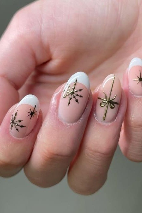 White nails with gold bow and snowflake art - classy Christmas nail idea for women over 70