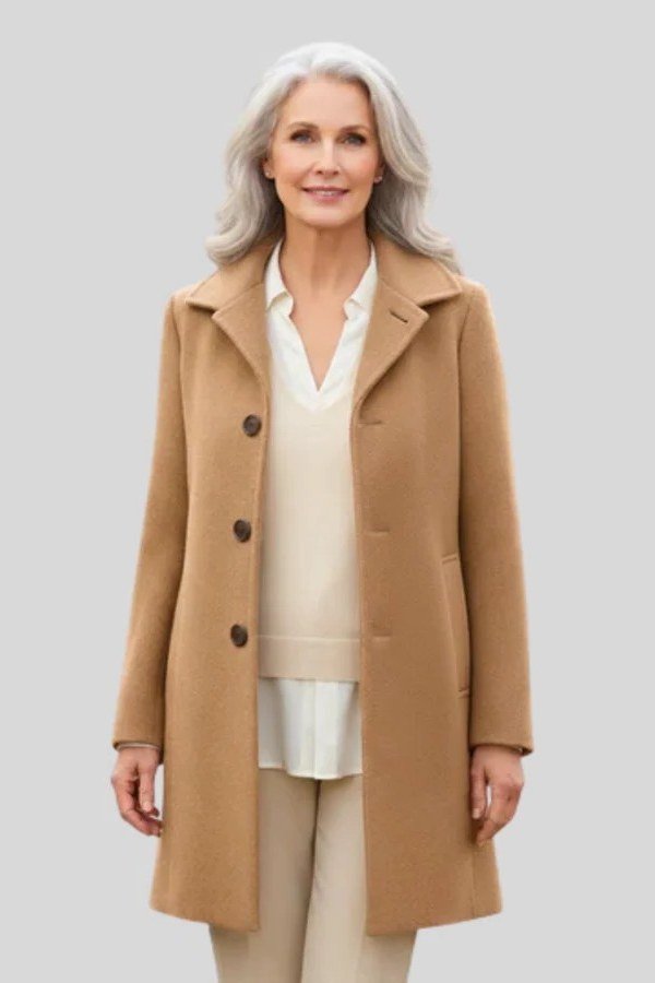 Camel midi coat over an all-cream outfit for women over 50 at work